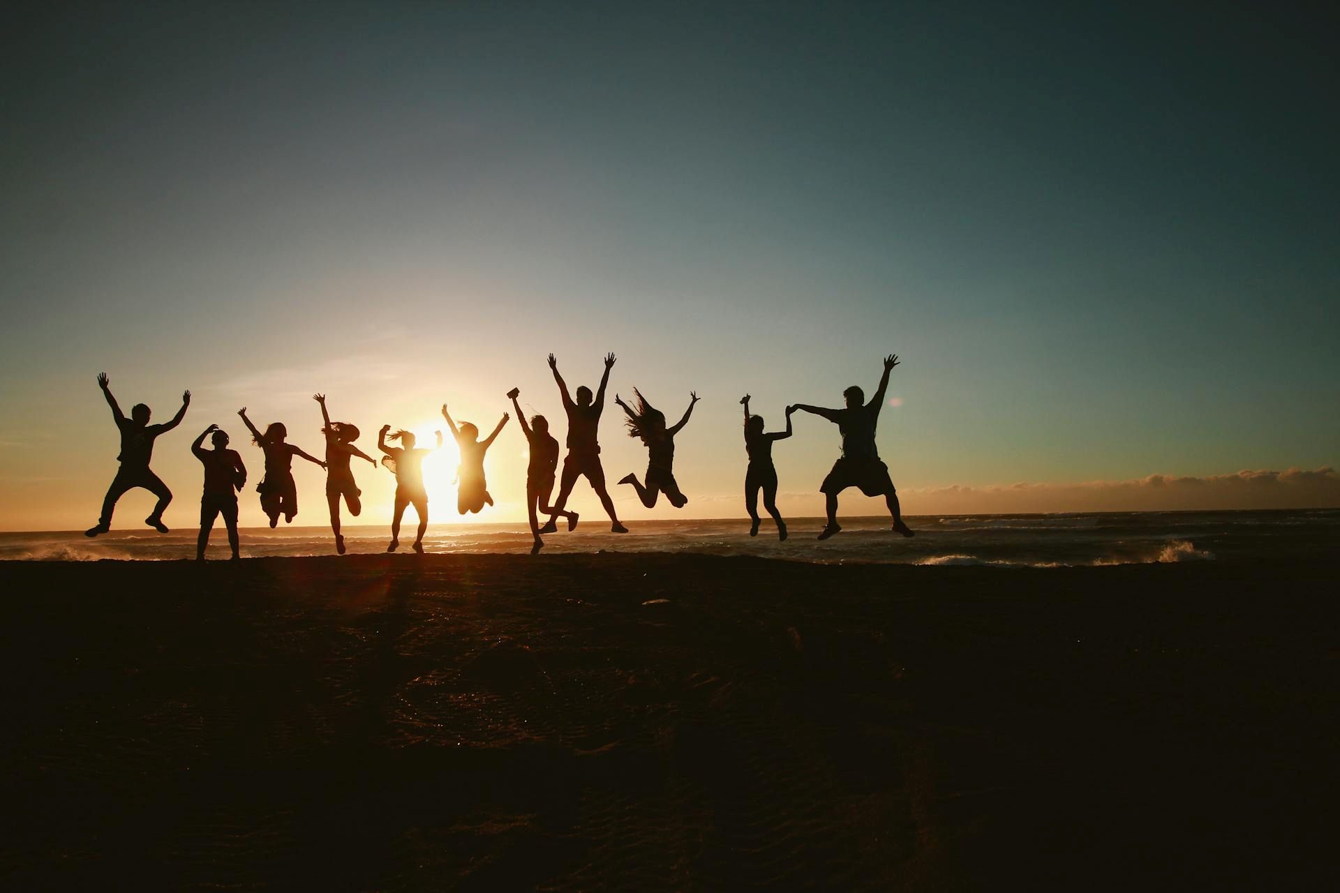 fotografia di un gruppo al tramonto mentre salta in aria
